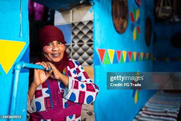 portrait of a islamic woman in the doorway at home - daily life in egypt stock pictures, royalty-free photos & images