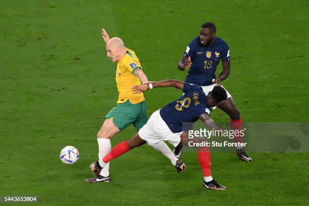 Aaron Mooy of Australia controls the ball against Aurelien Tchouameni and Dayot Upamecano of France during the FIFA World Cup Qatar 2022 Group D...