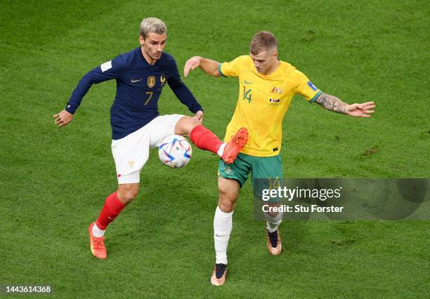 Antoine Griezmann of France and Riley McGree of Australia battle for the ball during the FIFA World Cup Qatar 2022 Group D match between France and...