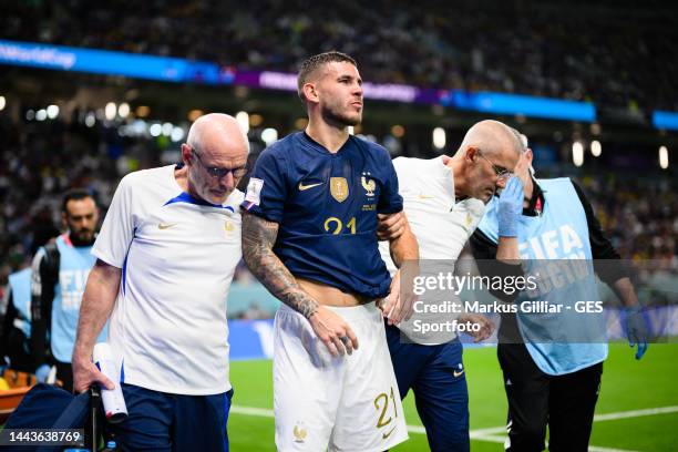 Lucas Hernandez of France is injured, receives medical treatment and needs to exchange during the FIFA World Cup Qatar 2022 Group D match between...