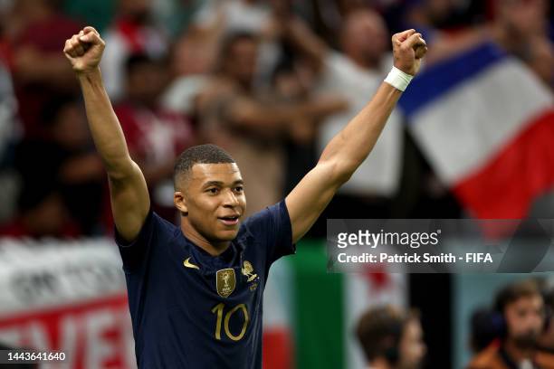 Kylian Mbappe of France celebrates his side's fourth goal scored by Olivier Giroud during the FIFA World Cup Qatar 2022 Group D match between France...