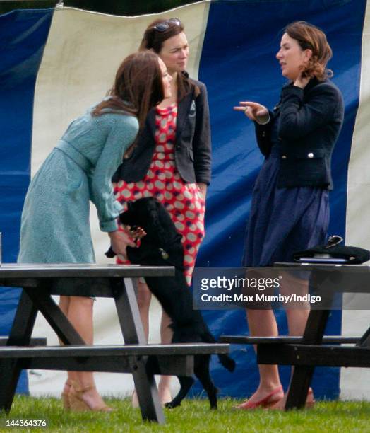 Catherine, Duchess of Cambridge with her dog Lupo, talks with Rebecca Deacon, The Cambridge's Deputy Private Secretary, as they attend the Audi Polo...