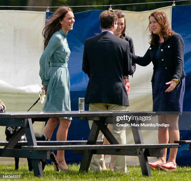 Catherine, Duchess of Cambridge with her dog Lupo, talks with Rebecca Deacon, The Cambridge's Deputy Private Secretary, as they attend the Audi Polo...