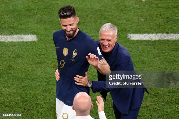 Olivier Giroud of France is congratulated by head coach Didier Deschamps after being substituted during the FIFA World Cup Qatar 2022 Group D match...
