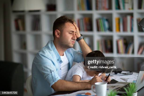 home office and parenthood at same time. exhausted parent with hyperactive child. - male preschooler stock pictures, royalty-free photos & images