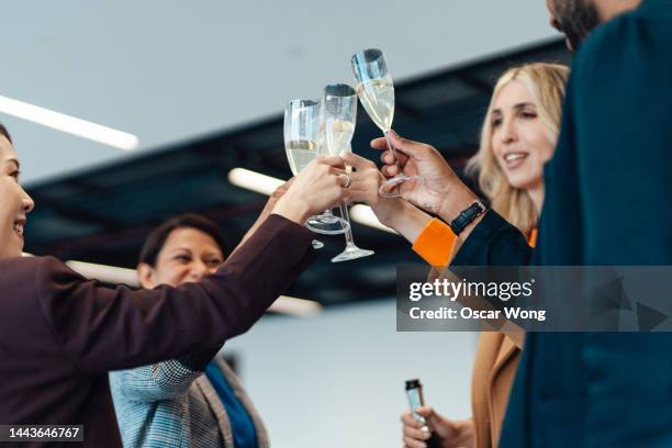multicultural team toasting to success at the office - drinking champagne stock pictures, royalty-free photos & images