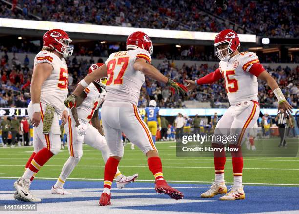 Travis Kelce of the Kansas City Chiefs celebrates his touchdown catch with Patrick Mahomes and Creed Humphrey, to take a 23-20 lead over the Los...