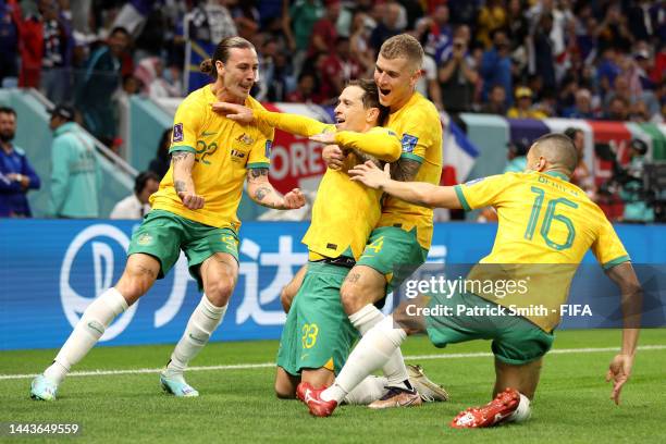 Craig Goodwin of Australia celebrates with teammates Jackson Irvine, Riley McGree and Aziz Behich after scoring their side's first goal during the...