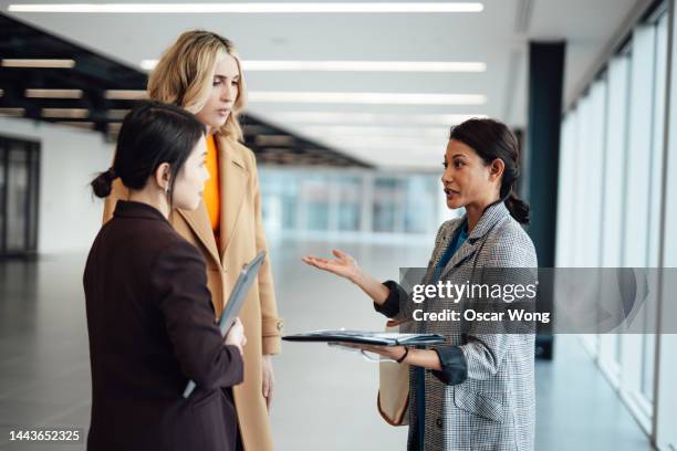 multi-racial group of businesswomen viewing new office space with an estate agent - real estate developer stock-fotos und bilder
