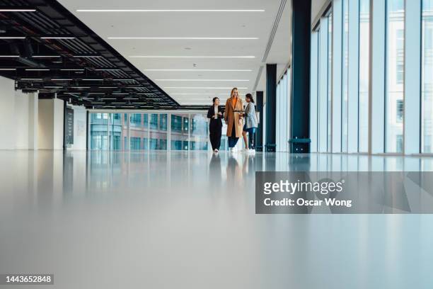 multi-racial group of businesswomen viewing new office space with an estate agent - possibilities stock pictures, royalty-free photos & images