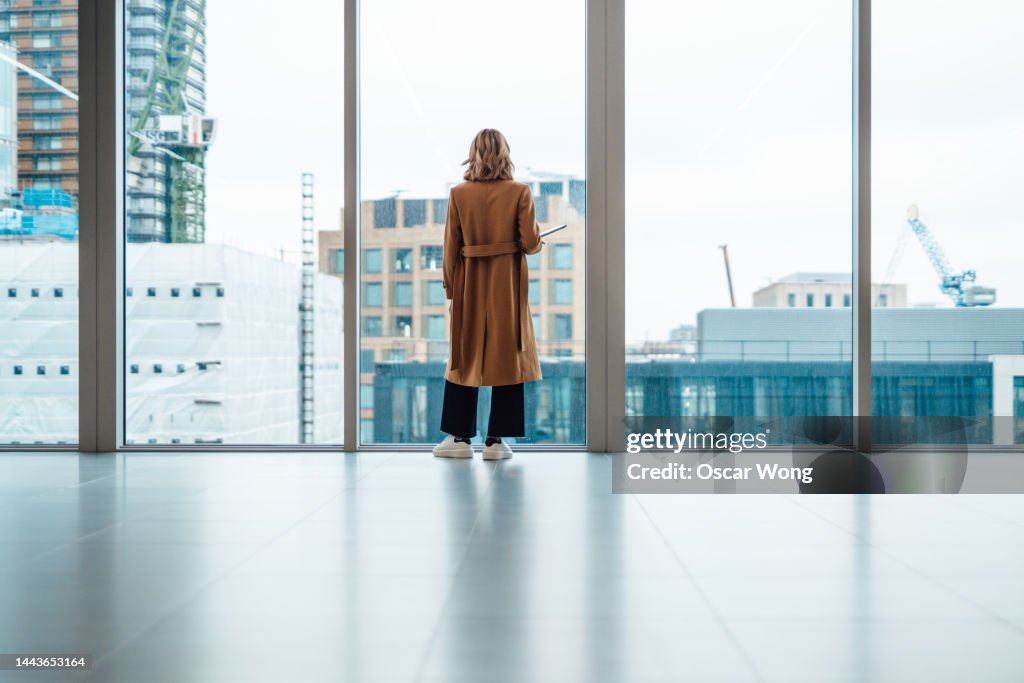 Businesswoman looking out window in meeting room