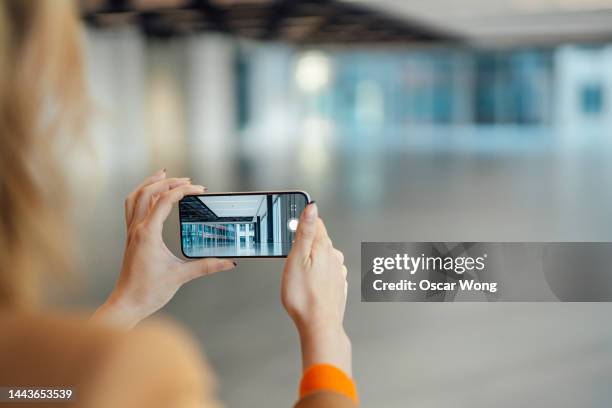 estate agent showing a new office space through an online video call - filming stock pictures, royalty-free photos & images