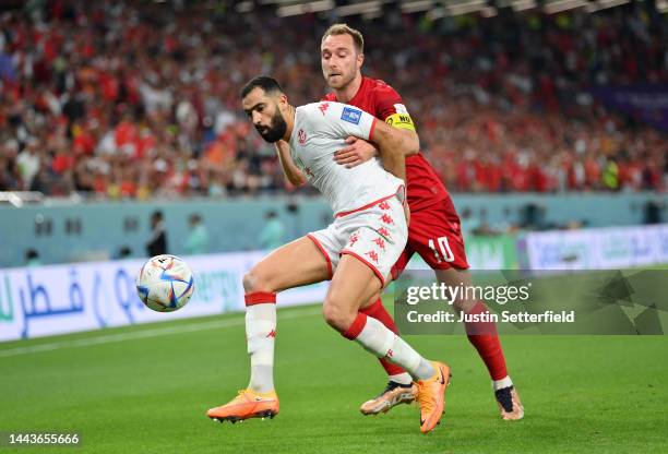 Yassine Meriah of Tunisia holds off Christian Eriksen of Denmark during the FIFA World Cup Qatar 2022 Group D match between Denmark and Tunisia at...