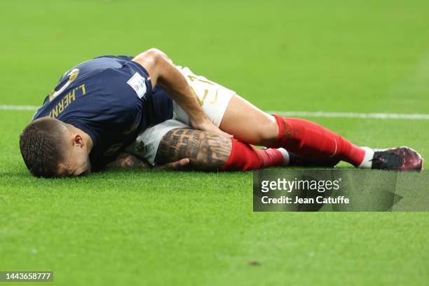Lucas Hernandez of France is injured early in the match and has to be substituted during the FIFA World Cup Qatar 2022 Group D match between France...