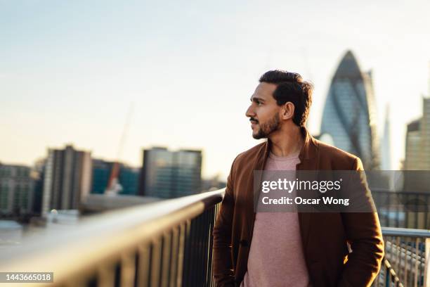 portrait of businessman on rooftop - looking away stock pictures, royalty-free photos & images