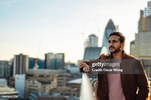 portrait of businessman on rooftop - portrait copy space stock pictures, royalty-free photos & images
