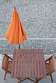 Table,chairs and orange sunshade