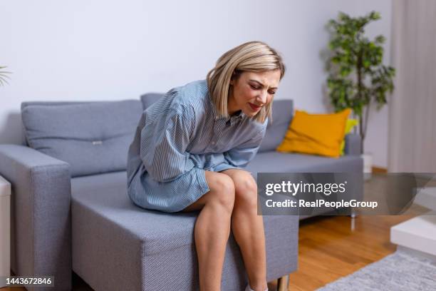 my period is early - woman bending over imagens e fotografias de stock