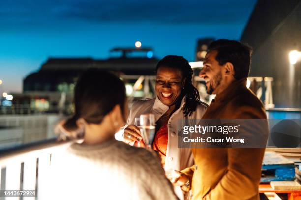 group of businesspeople having friday night drinks - cocktail corporate stockfoto's en -beelden