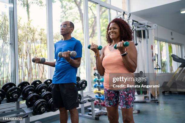 african american senior couple working out together - gym stock pictures, royalty-free photos & images