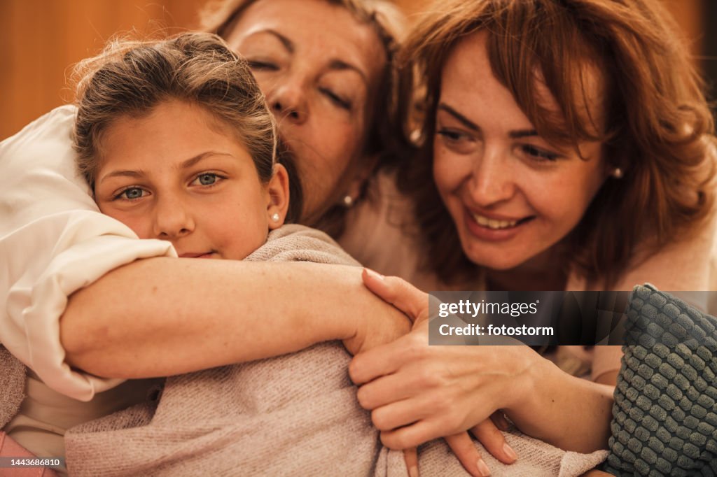 Three Generations Enjoying A Tight Hug During Cool Spring Day High-Res ...