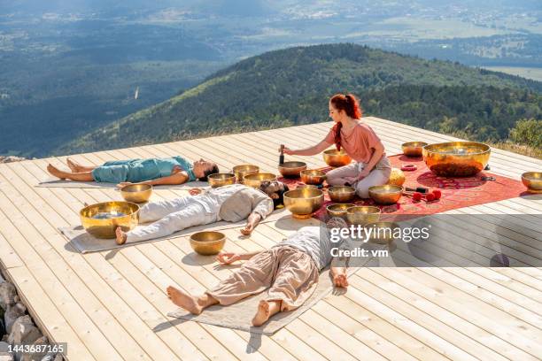 singing bowls meditation, people group at sound healing therapy session - rin gong stock pictures, royalty-free photos & images