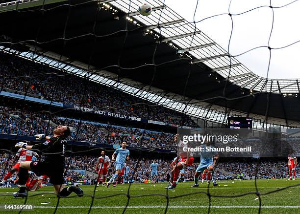 Goalkeeper Paddy Kenny of QPR deflects the shot from Pablo Zabaleta of Manchester City into his own net for the opening goal during the Barclays...