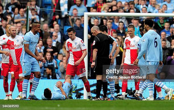 Joey Barton of QPR clashes with Sergio Aguero of Manchester City after being shown the red card by Referee Mike Dean during the Barclays Premier...