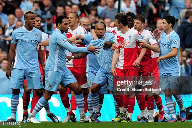 Joey Barton of QPR causes a fracas after being shown the red card by Referee Mike Dean during the Barclays Premier League match between Manchester...