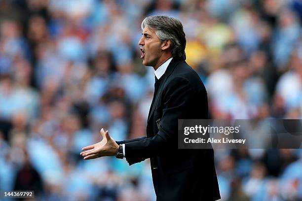 Roberto Mancini the manager of Manchester City reacts during the Barclays Premier League match between Manchester City and Queens Park Rangers at the...