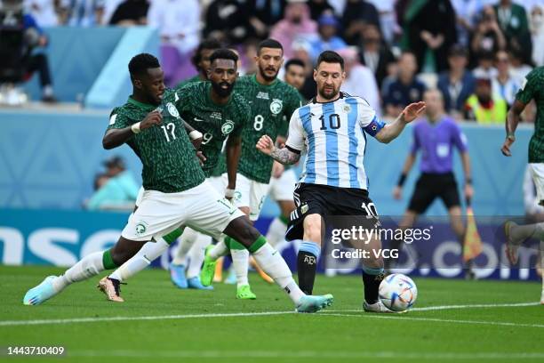 Lionel Messi of Argentina and Hassan Altambakti of Saudi Arabia compete for the ball during the FIFA World Cup Qatar 2022 Group C match between...