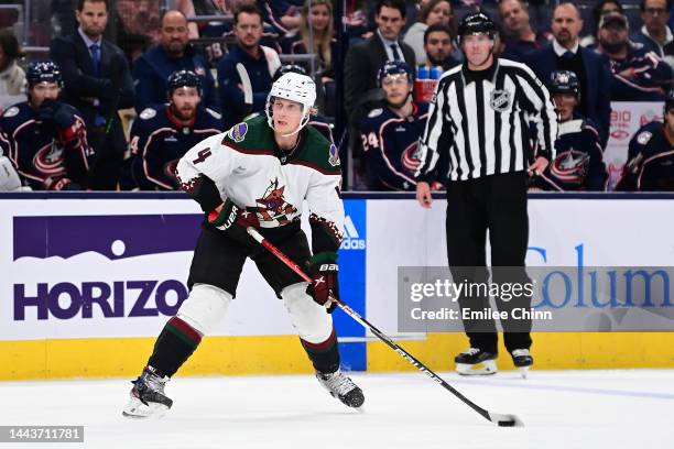 Juuso Valimaki of the Arizona Coyotes controls the puck during a game against the Columbus Blue Jackets at Nationwide Arena on October 25, 2022 in...