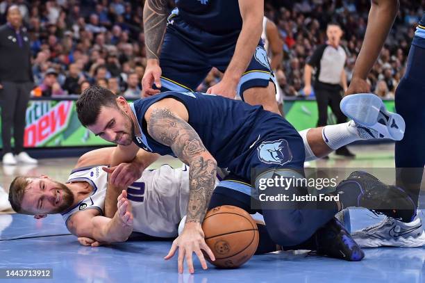 John Konchar of the Memphis Grizzlies and Domantas Sabonis of the Sacramento Kings battle for the ball during the first half at FedExForum on...