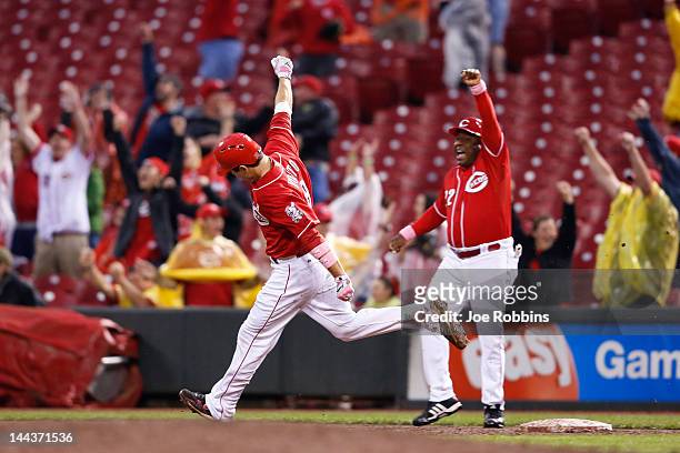Joey Votto of the Cincinnati Reds celebrates after hitting a grand slam in the ninth inning against the Washington Nationals at Great American Ball...