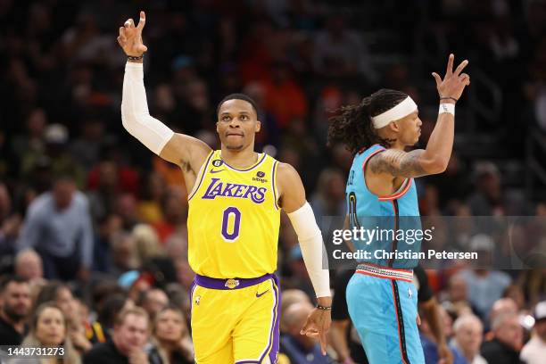 Russell Westbrook of the Los Angeles Lakers reacts to a three-point shot over Damion Lee of the Phoenix Suns during the first half of the NBA game at...