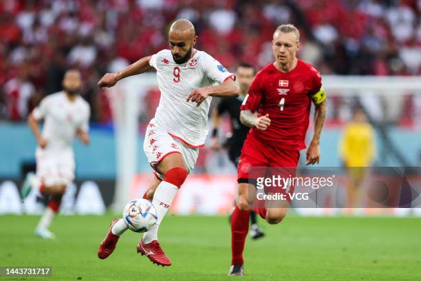 Simon Kjaer of Denmark and Issam Jebali of Tunisia compete for the ball during the FIFA World Cup Qatar 2022 Group D match between Denmark and...