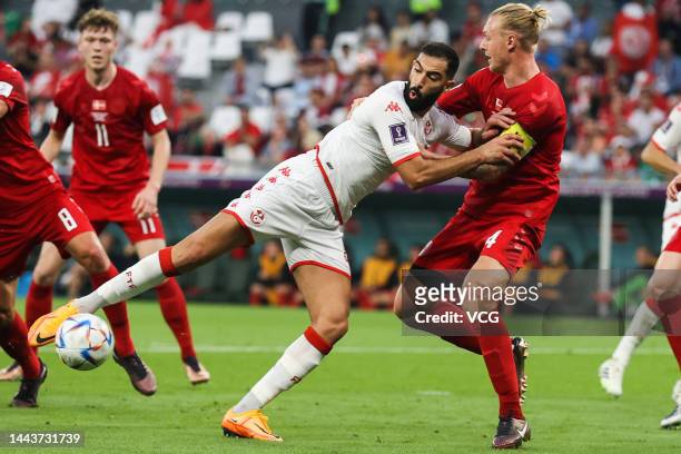 Simon Kjaer of Denmark and Yassine Meriah of Tunisia compete for the ball during the FIFA World Cup Qatar 2022 Group D match between Denmark and...
