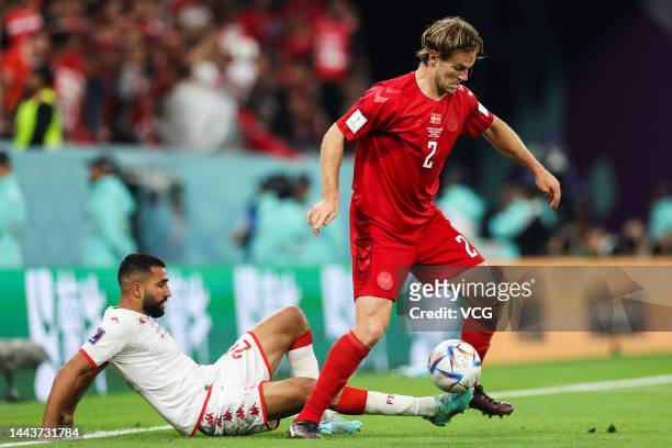 Joachim Andersen of Denmark and Ali Abdi of Tunisia compete for the ball during the FIFA World Cup Qatar 2022 Group D match between Denmark and...