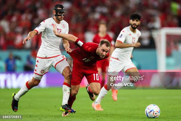 Christian Eriksen of Denmark drives the ball against Ellyes Skhiri of Tunisia during the FIFA World Cup Qatar 2022 Group D match between Denmark and...