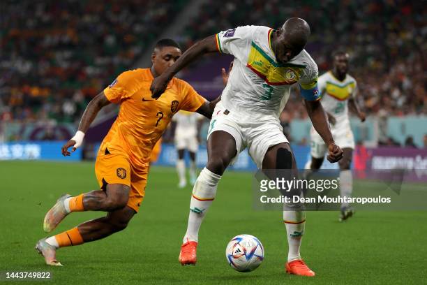 Kalidou Koulibaly of Senegal battles for the ball with Steven Bergwijn of Netherlands during the FIFA World Cup Qatar 2022 Group A match between...