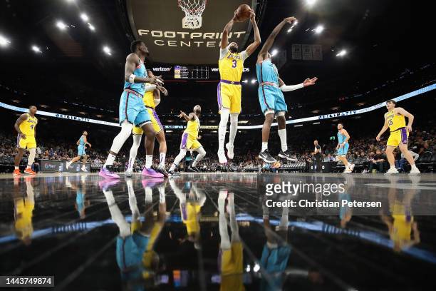 Anthony Davis of the Los Angeles Lakers grabs a rebound over Torrey Craig of the Phoenix Suns during the second half of the NBA game at Footprint...