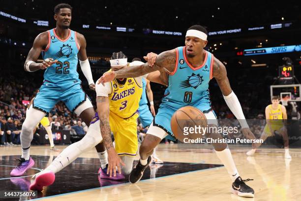 Torrey Craig of the Phoenix Suns attempts to control the ball ahead of Anthony Davis of the Los Angeles Lakers during the second half of the NBA game...