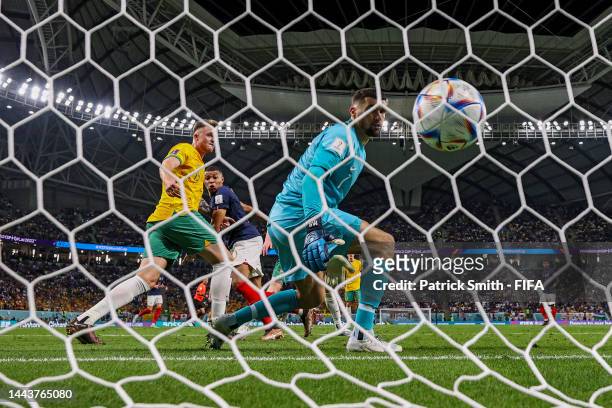 Kylian Mbappe of France watches his team's third goal go into the net past Harry Souttar of Australia during the FIFA World Cup Qatar 2022 Group D...