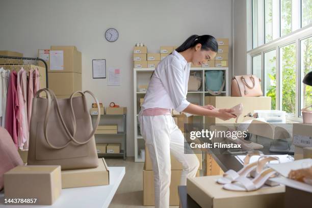 asian woman online seller checking stock and inventory before sending to the customer. - shoe seller imagens e fotografias de stock