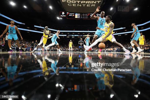 Kendrick Nunn of the Los Angeles Lakers handles the ball against Bismack Biyombo of the Phoenix Suns during the first half of the NBA game at...