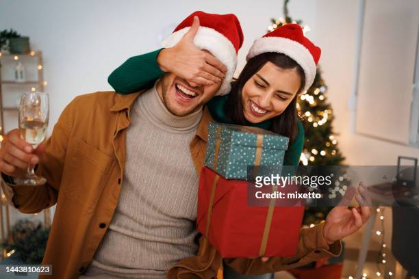 xmas surprise. loving wife giving gift to husband - young couple date night wine stock pictures, royalty-free photos & images