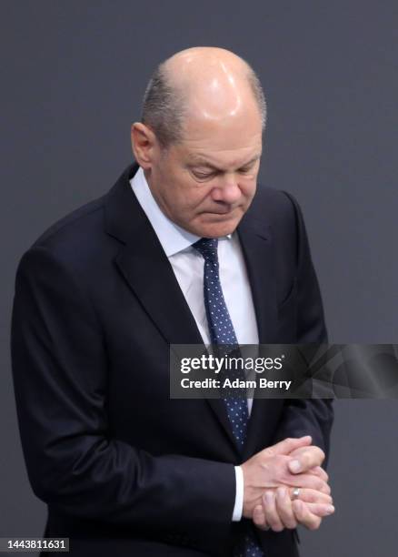 German Federal Chancellor Olaf Scholz prepares to speak as he attends a debate over the country's 2023 federal budget in the Reichstag, seat of the...