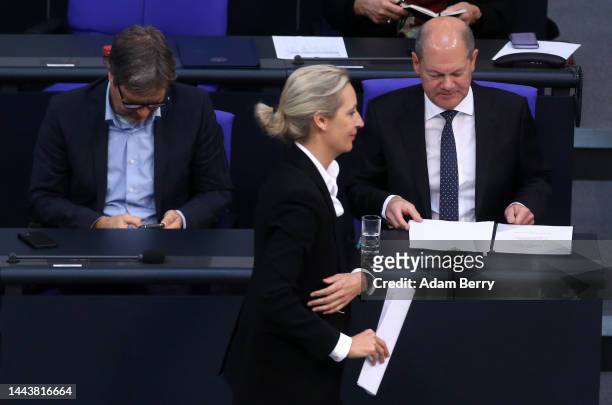 Alice Weidel, co-leader of the Alternative for Germany party, passes German Federal Chancellor Olaf Scholz as they attend a debate over the country's...