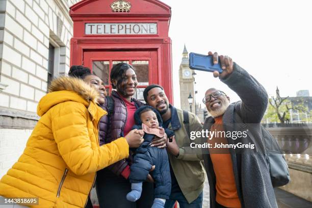 three-generation black family taking selfie in london - group of people on phones stock pictures, royalty-free photos & images
