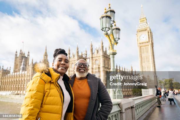 autumn portrait of mature black couple vacationing in london - person falls from westminster bridge stock pictures, royalty-free photos & images